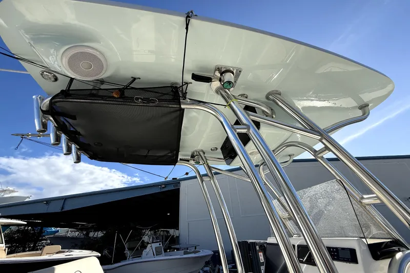 Slide: The Image of 2021 Key West 239 FS boat with T-top and rod holders, under clear blue sky. - 4
