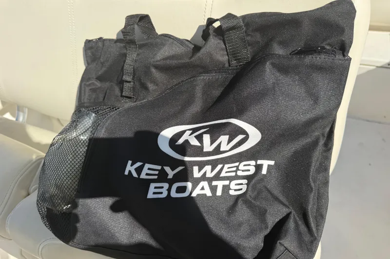 Slide: The Image of Black Key West Boats bag on a boat seat, featuring the logo prominently. - 8