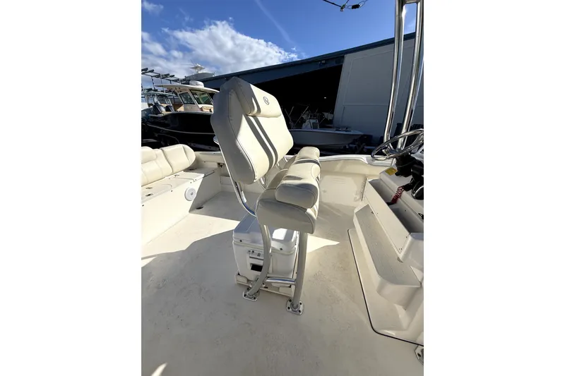 Slide: The Image of 2021 Key West 239 FS boat interior with cushioned seating and steering console. - 9