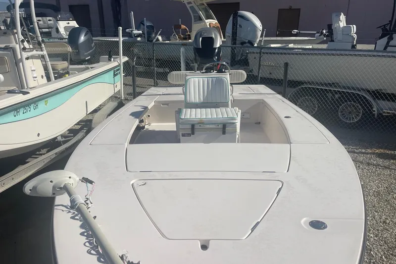 Slide: The Image of 2004 Maverick Master Angler 18 boat in storage, featuring a clean deck and seating. - 10
