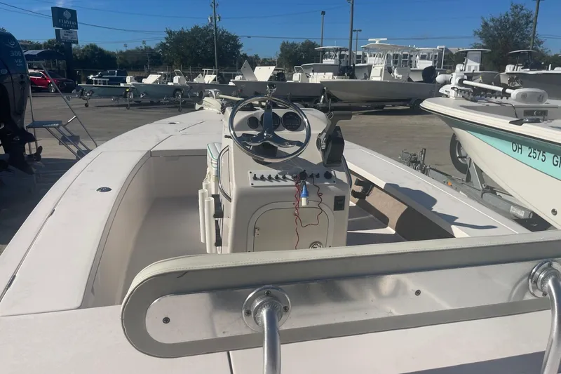 Slide: The Image of 2004 Maverick Master Angler 18 boat, white interior, parked in a marina with other boats. - 11