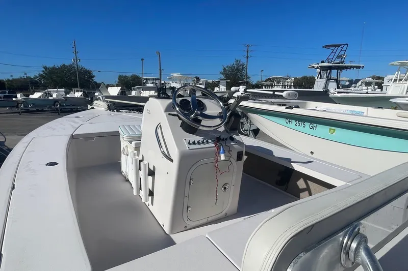 Slide: The Image of 2004 Maverick Master Angler 18 boat with steering console, docked under clear blue sky. - 4