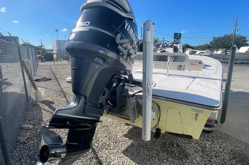 Slide: The Image of 2004 Maverick Master Angler 18 boat with Yamaha outboard motor in a marina setting. - 5