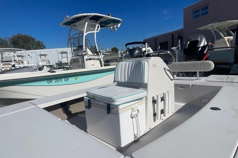 Slide: The Image of 2004 Maverick Master Angler 18 boat with seating and storage, parked outdoors. - 9