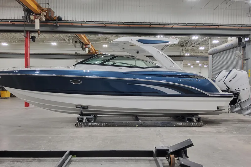 The Image of 2026 Formula 330 Crossover Bowrider OB in a showroom, featuring sleek design and Mercury outboard engines. - 0