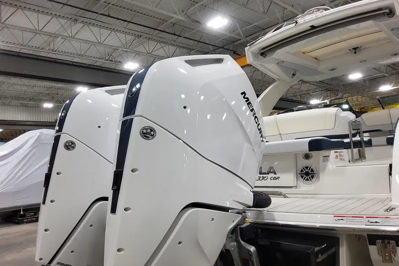 Slide: The Image of 2026 Formula 330 Crossover Bowrider OB with dual Mercury outboard engines in a showroom. - 16