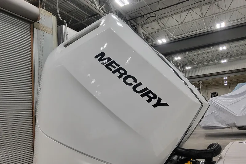 Slide: The Image of 2026 Formula 330 Crossover Bowrider OB with Mercury outboard engine in a warehouse. - 17