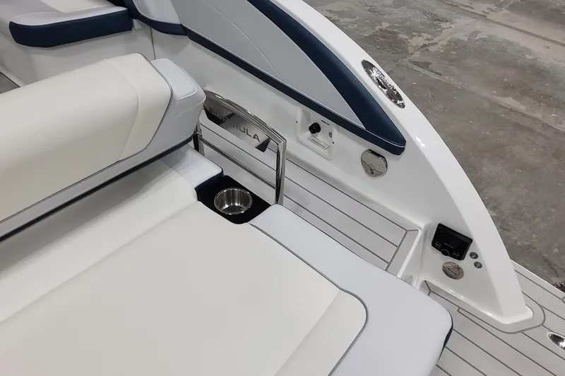 Slide: The Image of 2026 Formula 330 Crossover Bowrider OB interior with white seating and cup holder. - 22