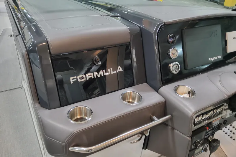 Slide: The Image of 2026 Formula 330 Crossover Bowrider OB dashboard with Raymarine display and cup holders. - 41