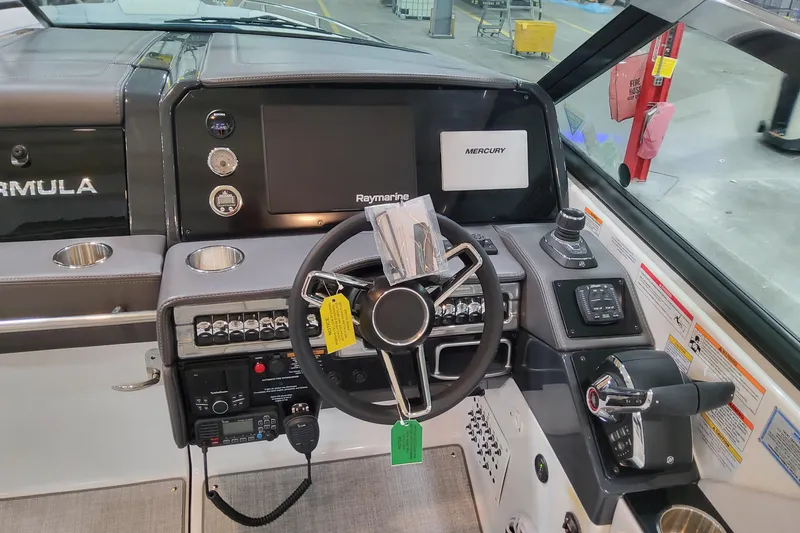Slide: The Image of 2026 Formula 330 Crossover Bowrider OB dashboard with steering wheel and navigation controls. - 44