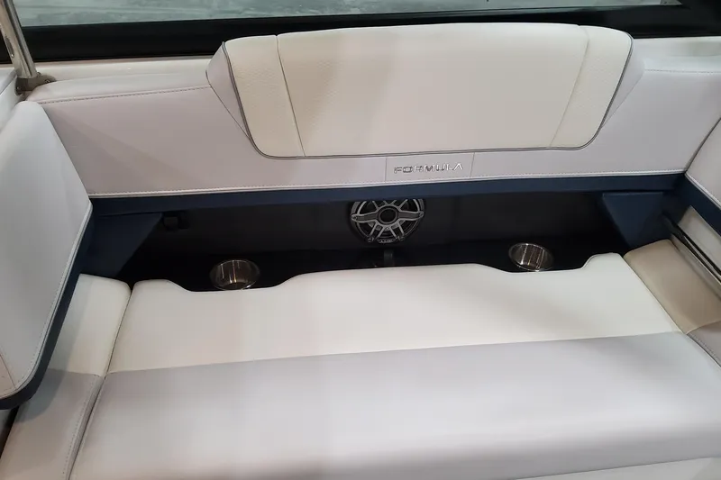 Slide: The Image of 2026 Formula 330 Crossover Bowrider OB interior seating with cup holders and speaker. - 46