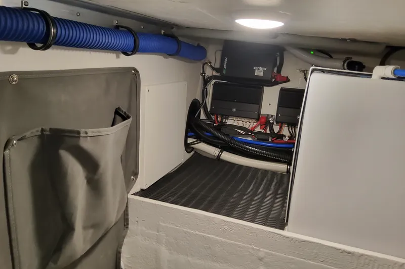 Slide: The Image of 2026 Formula 330 Crossover Bowrider OB engine compartment with wiring and storage. - 54