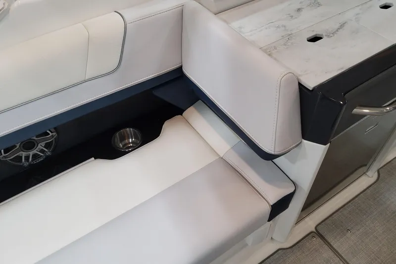 Slide: The Image of 2026 Formula 330 Crossover Bowrider OB interior seating with cup holder and speaker. - 56