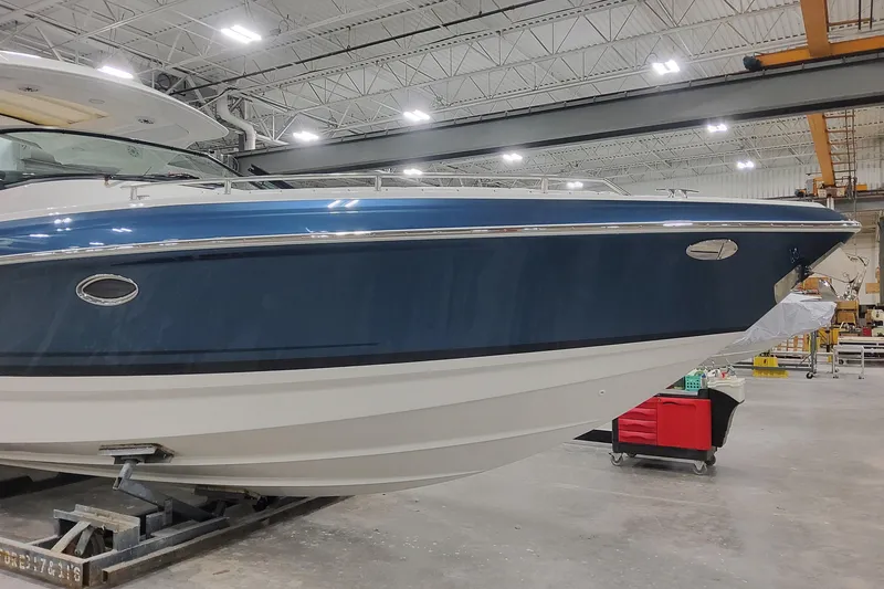 Slide: The Image of 2026 Formula 330 Crossover Bowrider OB in a showroom, showcasing sleek design and craftsmanship. - 6