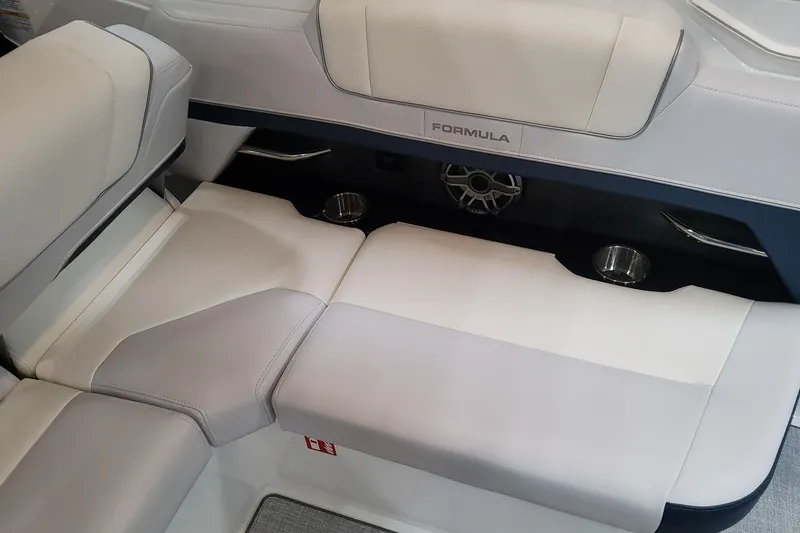 Slide: The Image of 2026 Formula 330 Crossover Bowrider OB interior seating with cup holders and speaker. - 65