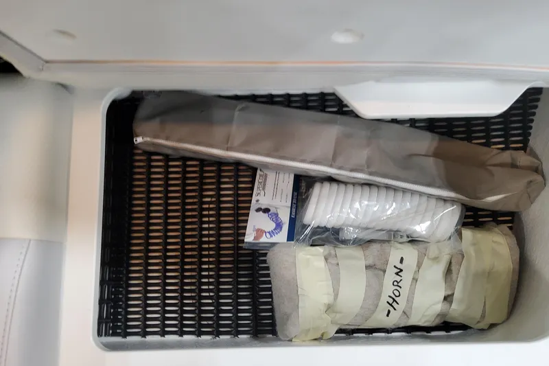 Slide: The Image of Storage compartment in 2026 Formula 330 Crossover Bowrider OB with boating accessories. - 67