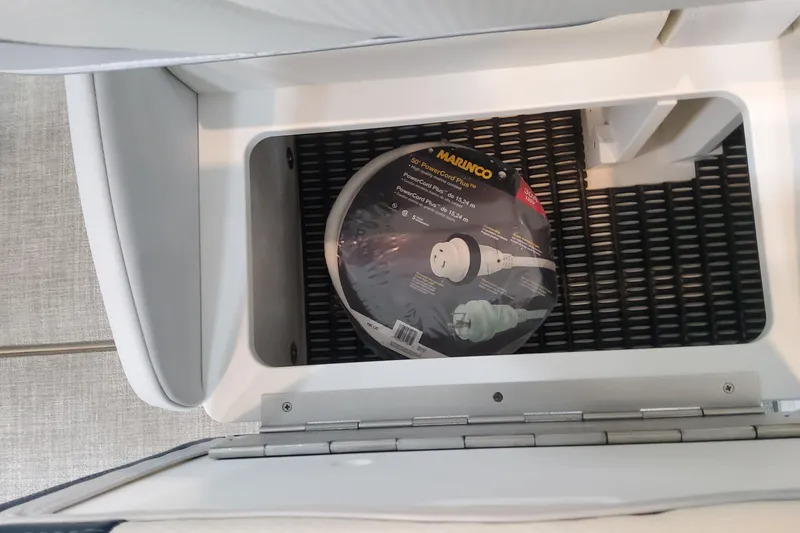 Slide: The Image of Storage compartment in 2026 Formula 330 Crossover Bowrider OB with Marinco power cord. - 68