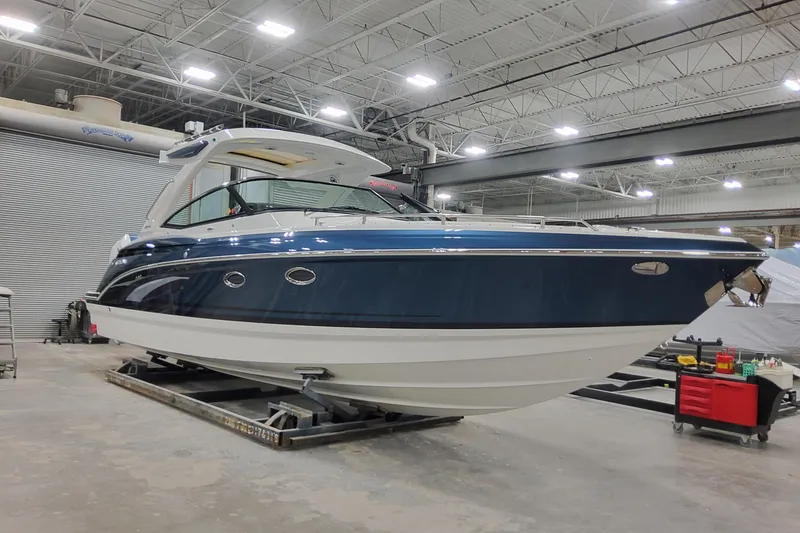 Slide: The Image of 2026 Formula 330 Crossover Bowrider OB in a showroom, showcasing sleek design and modern features. - 7