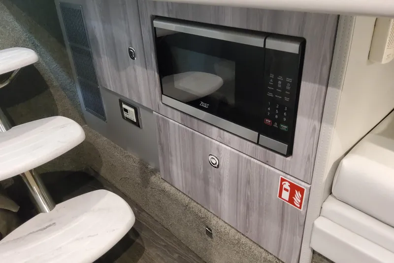 Slide: The Image of 2026 Formula 330 Crossover Bowrider OB interior with microwave and modern design. - 78