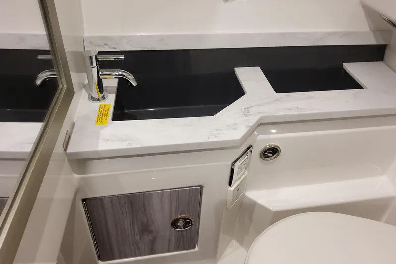 Slide: The Image of 2026 Formula 330 Crossover Bowrider OB bathroom with modern sink and sleek design. - 81