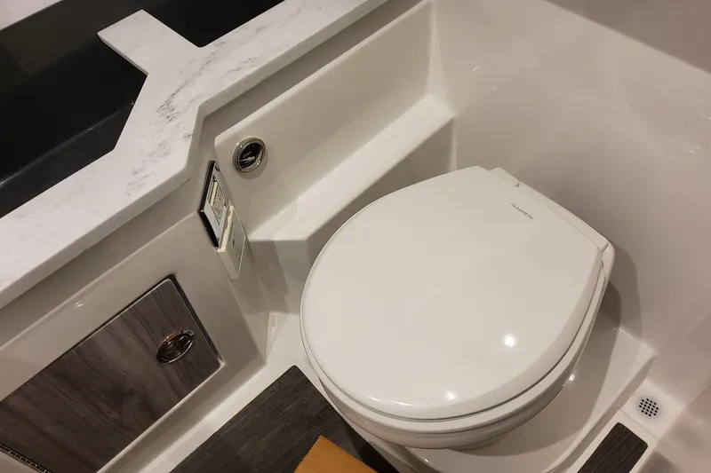 Slide: The Image of 2026 Formula 330 Crossover Bowrider OB bathroom with modern toilet and sleek design. - 83