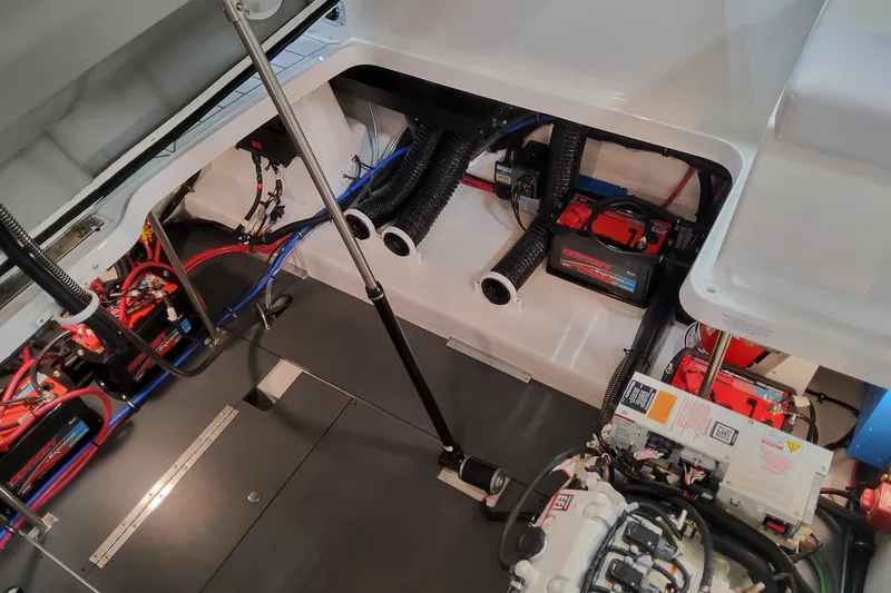 Slide: The Image of Engine compartment of 2026 Formula 330 Crossover Bowrider OB with visible wiring and components. - 89