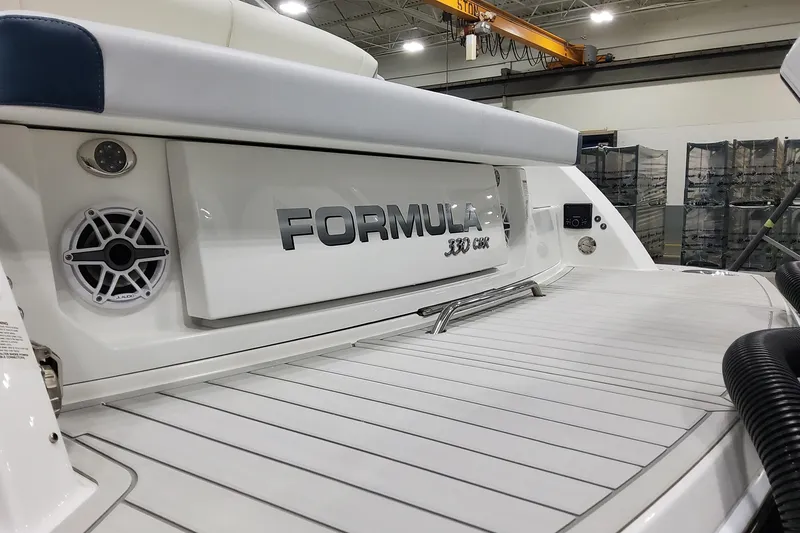 Slide: The Image of 2026 Formula 330 Crossover Bowrider OB boat interior with speaker and branding. - 9