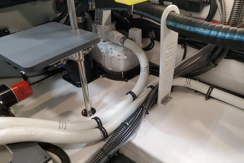 Slide: The Image of Engine compartment of 2026 Formula 330 Crossover Bowrider OB with hoses and wiring. - 91