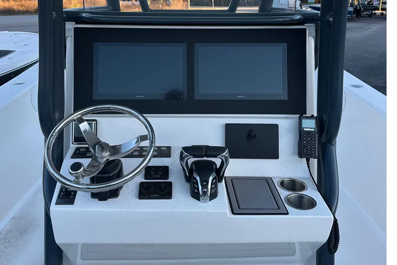 Slide: The Image of 2024 Sea Born LX 26 LE boat dashboard with dual screens and steering wheel. - 10