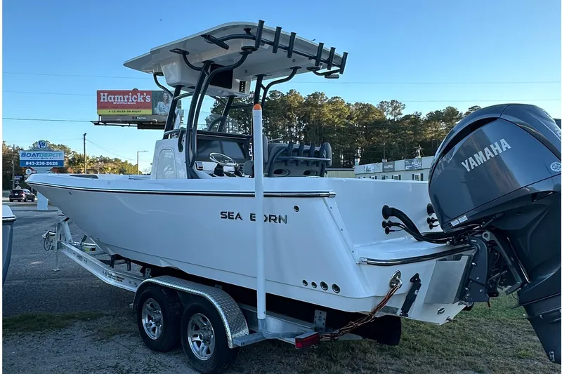 Slide: The Image of 2024 Sea Born LX 26 LE boat with Yamaha engine on trailer, parked outdoors. - 3