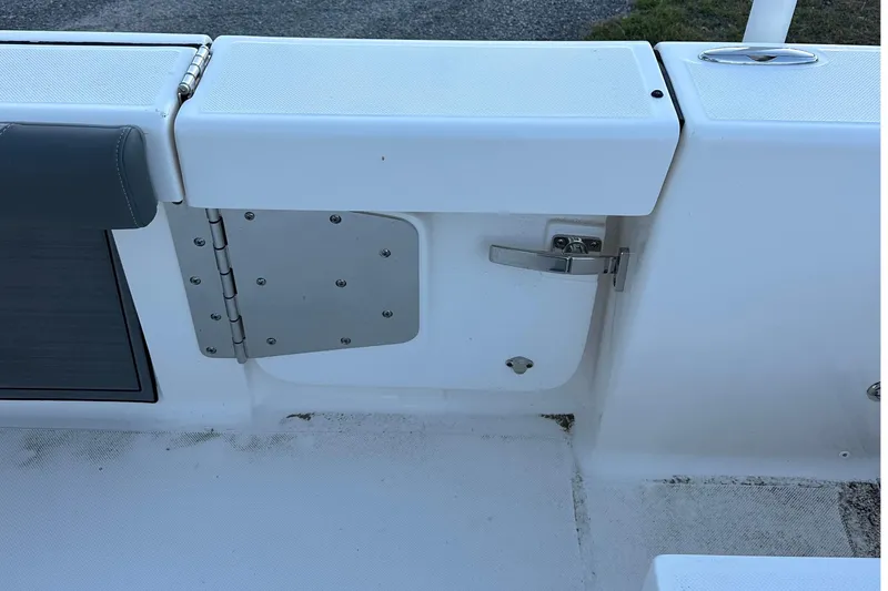 Slide: The Image of 2024 Sea Born LX 26 LE boat interior detail with storage compartment and latch. - 5