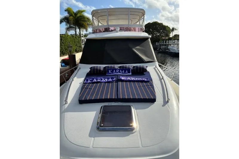 Slide: The Image of 2007 Pama 540 LX Pilothouse yacht with striped cushions and "Karma" pillows on deck. - 19