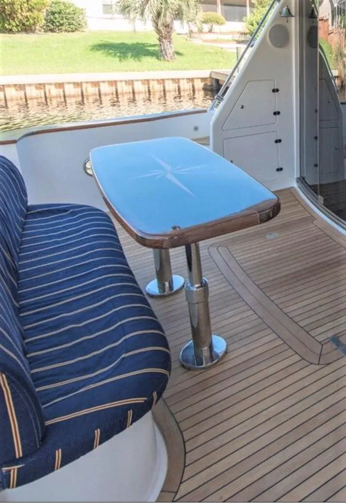 Slide: The Image of 2007 Pama 540 LX Pilothouse yacht with striped seating and wooden deck. - 20