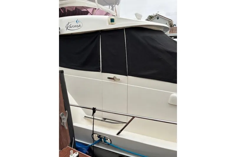 Slide: The Image of 2007 Pama 540 LX Pilothouse yacht with black window covers, docked. - 21