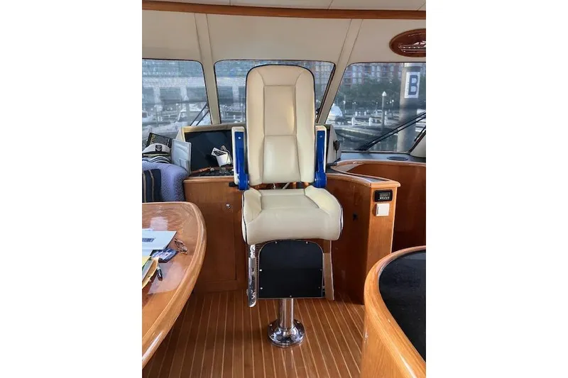 Slide: The Image of Pilothouse interior of 2007 Pama 540 LX, featuring a central captain's chair and wooden accents. - 23