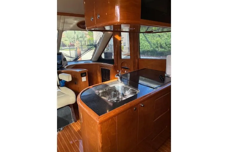 Slide: The Image of Luxurious 2007 Pama 540 LX Pilothouse interior with sleek wood cabinetry and modern amenities. - 24