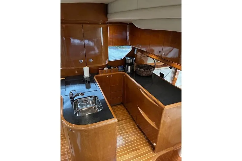 Slide: The Image of Luxurious kitchen interior of 2007 Pama 540 LX Pilothouse yacht with wood cabinetry. - 25