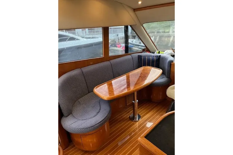 Slide: The Image of 2007 Pama 540 LX Pilothouse interior with curved seating and wooden table. - 27