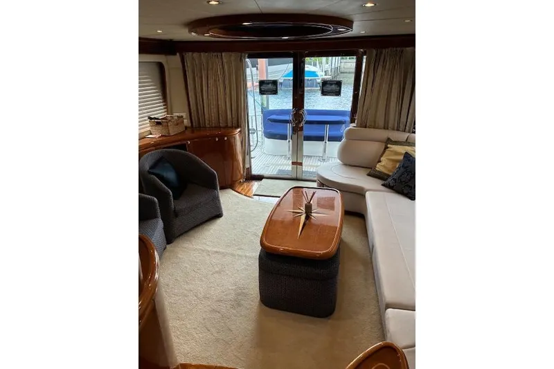 Slide: The Image of Luxurious interior of 2007 Pama 540 LX Pilothouse yacht with elegant seating and wooden accents. - 30