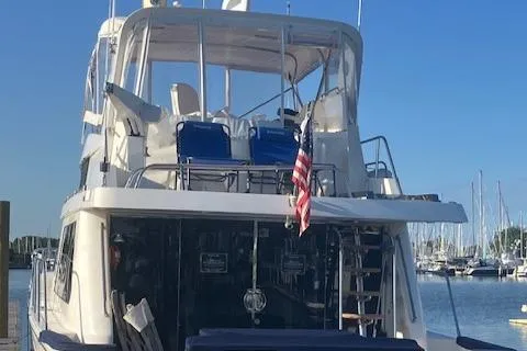 Slide: The Image of 2007 Pama 540 LX Pilothouse yacht docked at marina with American flag. - 4