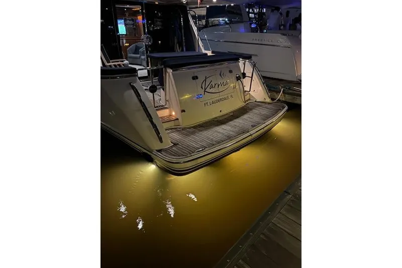 Slide: The Image of 2007 Pama 540 LX Pilothouse yacht docked at night, illuminated by underwater lights. - 8