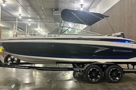 The Image of 2024 Crownline 240 SS boat on trailer in indoor showroom. - 0