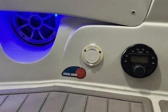 Slide: The Image of 2024 Crownline 240 SS boat interior with speaker, control panel, and blue LED lighting. - 6