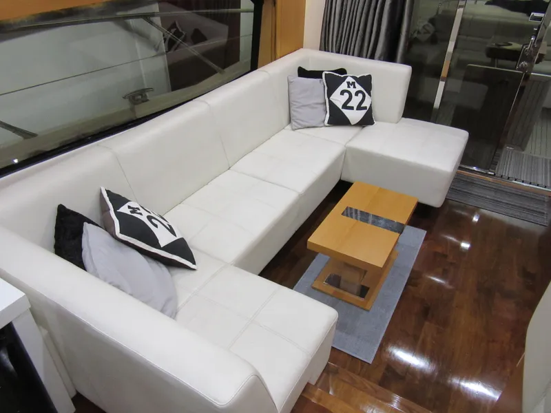 Slide: The Image of Luxurious interior of 2014 Sunseeker Manhattan 53 yacht with white leather seating and decorative pillows. - 11