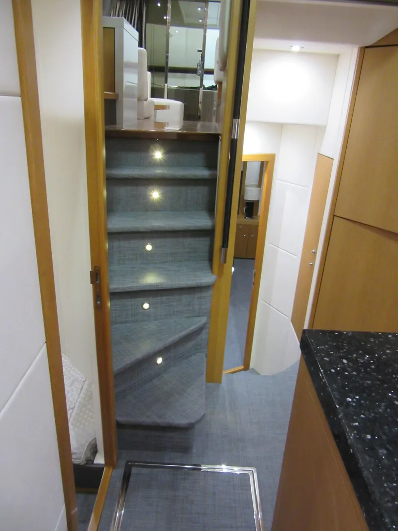 Slide: The Image of Interior staircase of 2014 Sunseeker Manhattan 53 yacht, featuring modern design and ambient lighting. - 17
