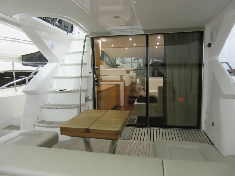 Slide: The Image of 2014 Sunseeker Manhattan 53 yacht interior with seating, table, and staircase. - 2