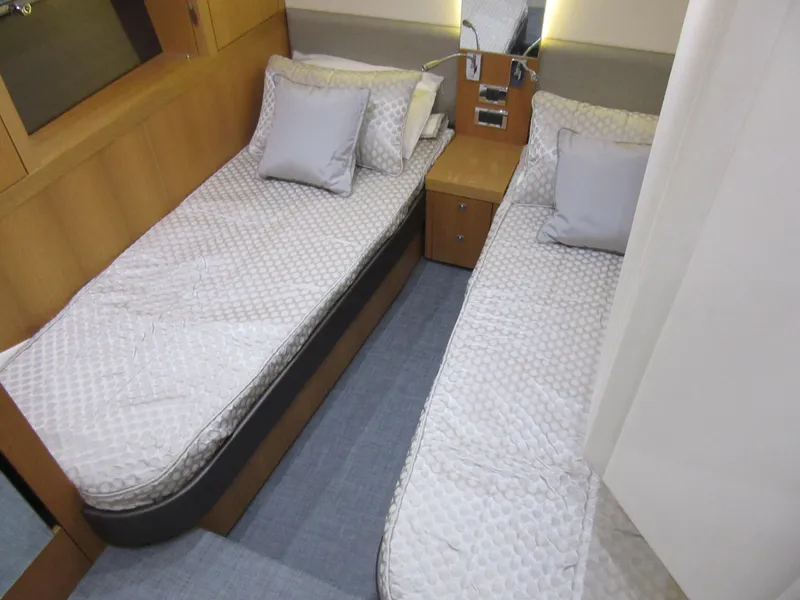 Slide: The Image of Twin cabin in 2014 Sunseeker Manhattan 53 yacht with modern decor and cozy bedding. - 25
