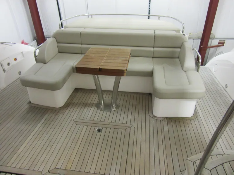 Slide: The Image of Luxurious seating area on 2014 Sunseeker Manhattan 53 yacht with wooden table. - 3