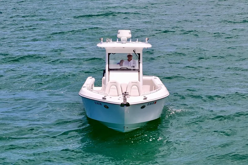 Slide: The Image of 2015 Everglades 295 Center Console boat navigating on clear blue water. - 12