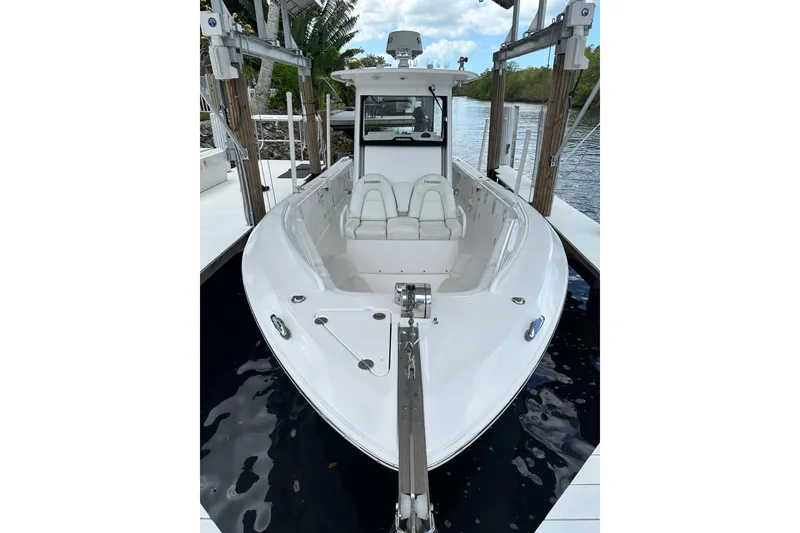Slide: The Image of 2015 Everglades 295 Center Console boat docked on calm water. - 18